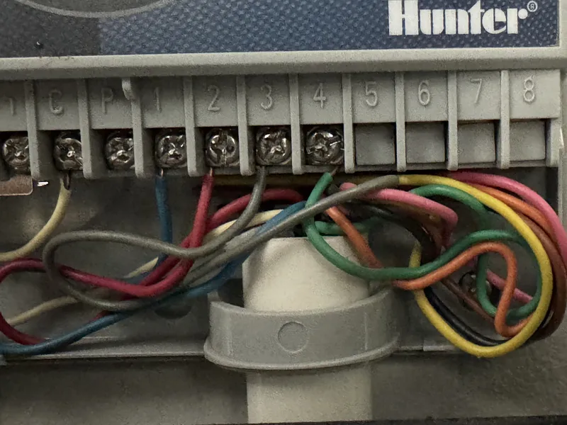 Hunter controller with color-coded zone wires connected to the terminal strip