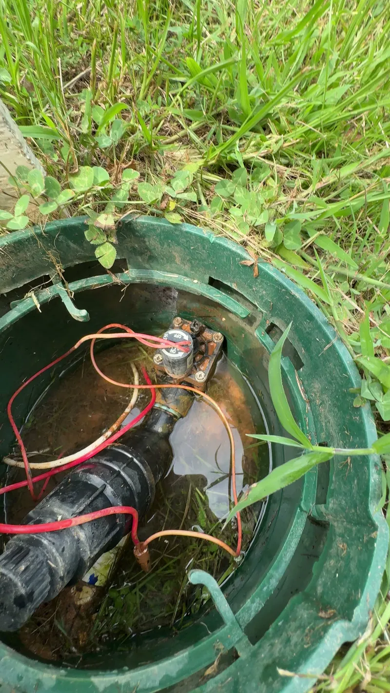 Irrigation valve and wire connections inside a round green valve box